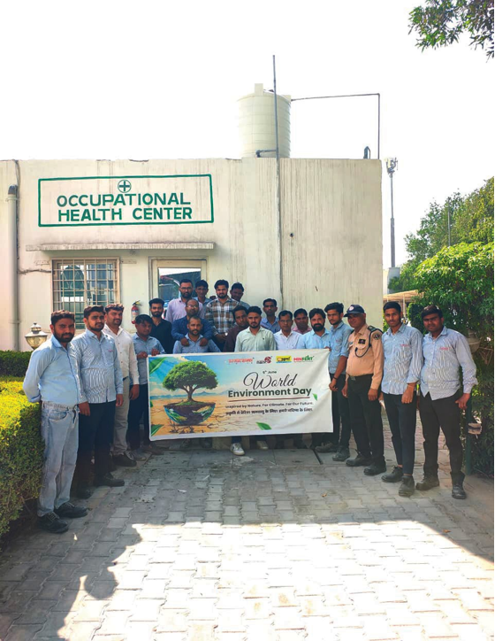 Employees and community members planting trees for Environment Day